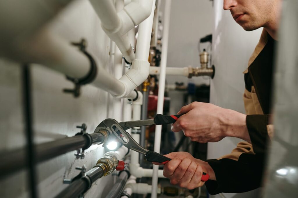 Plumbers maintaining commercial plumbing pipes in Phoenixville