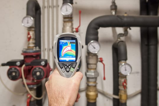 Plumber using a thermal imaging camera to inspect pipes in Phoenixville